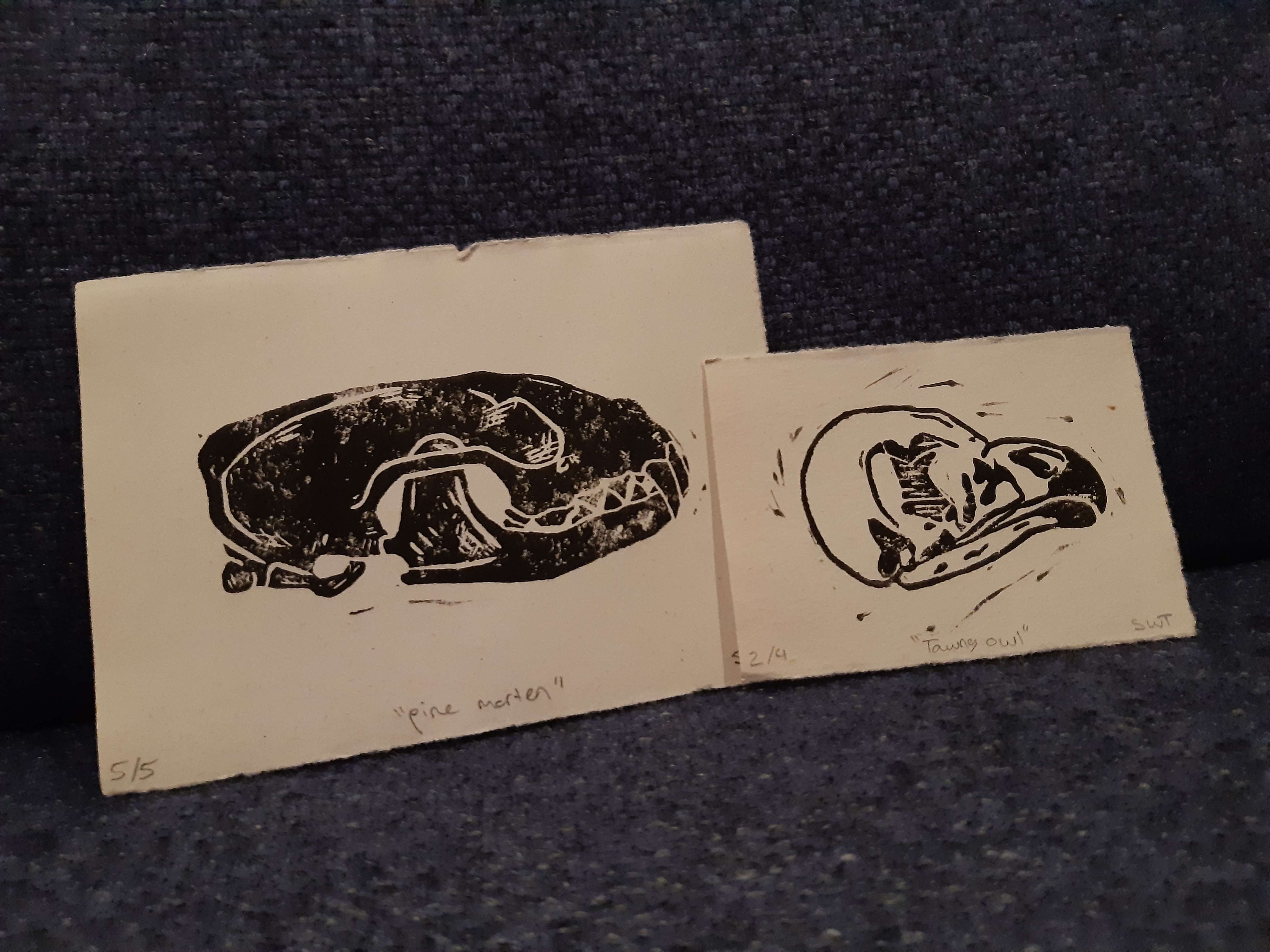 two linocut prints depicting animal skulls from the side.