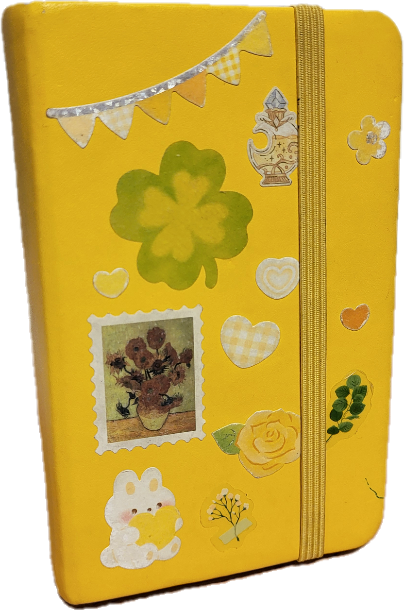yellow sketchbook with various stickers.